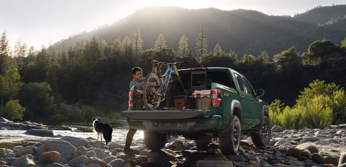 2023 Nissan Frontier carrying touristic equipment in nature landscape