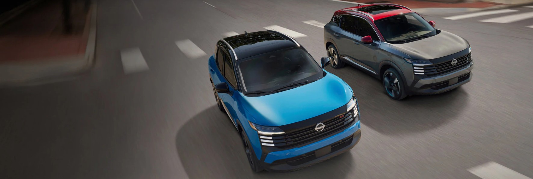 two 2025 nissan kicks driving side by side